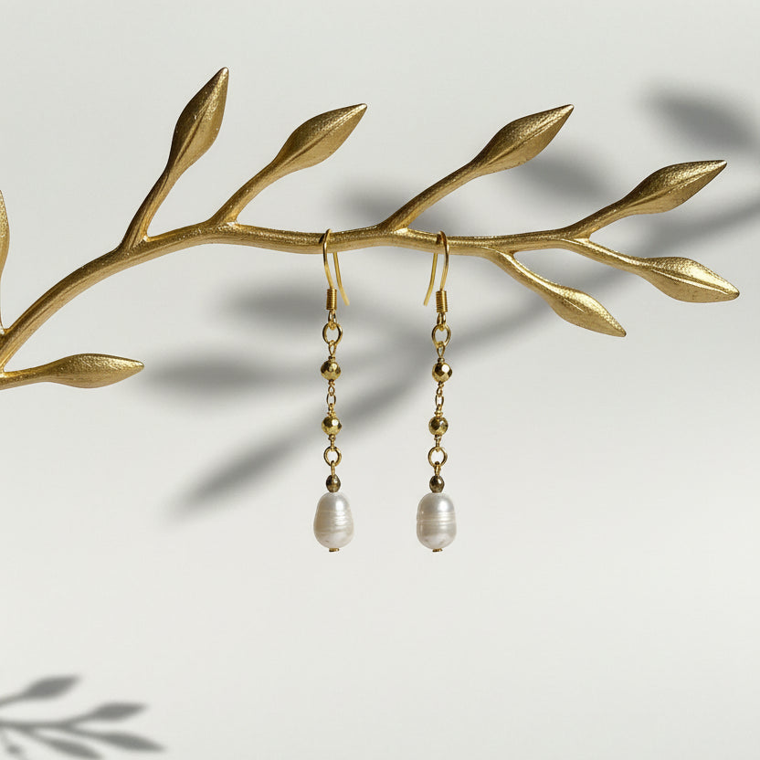 Close-up of gold pyrite chain earring with freshwater potato pearl drop, June birthstone jewelry