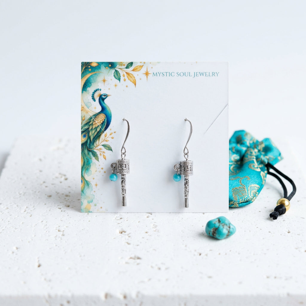 Silver-plated prayer wheel earrings with turquoise blue beads, shown with gift tag and satin pouch