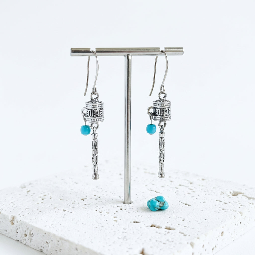 Silver-plated Tibetan prayer wheel drop earrings with turquoise blue beads
