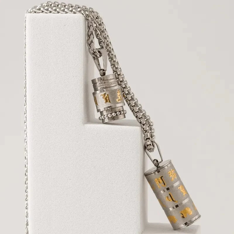 Silver necklace with cylindrical pendants on a white background