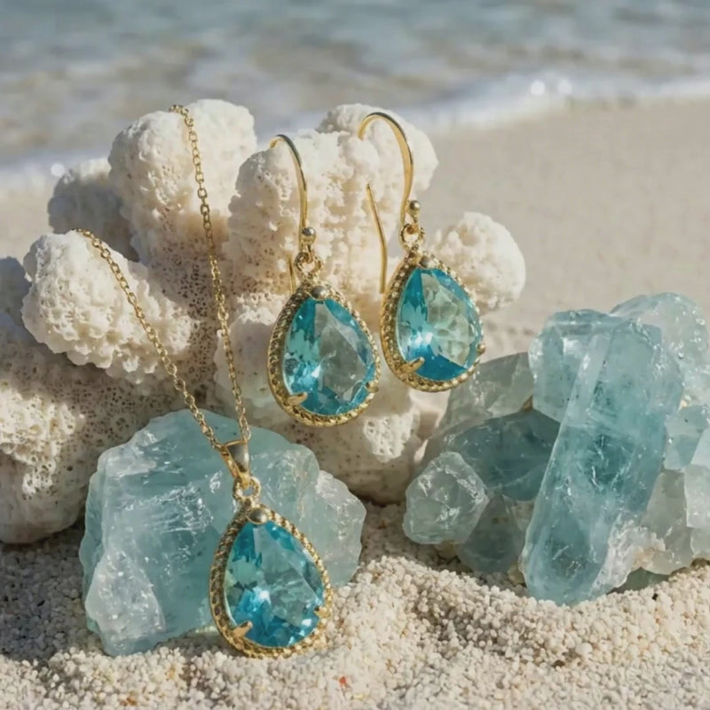 sand and ocean with gold and aqua necklace and earrings