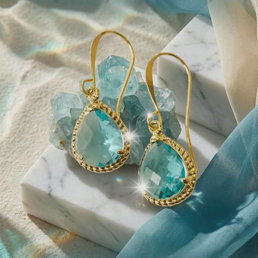 Load video: aqua exquisite earrings moving with water behind