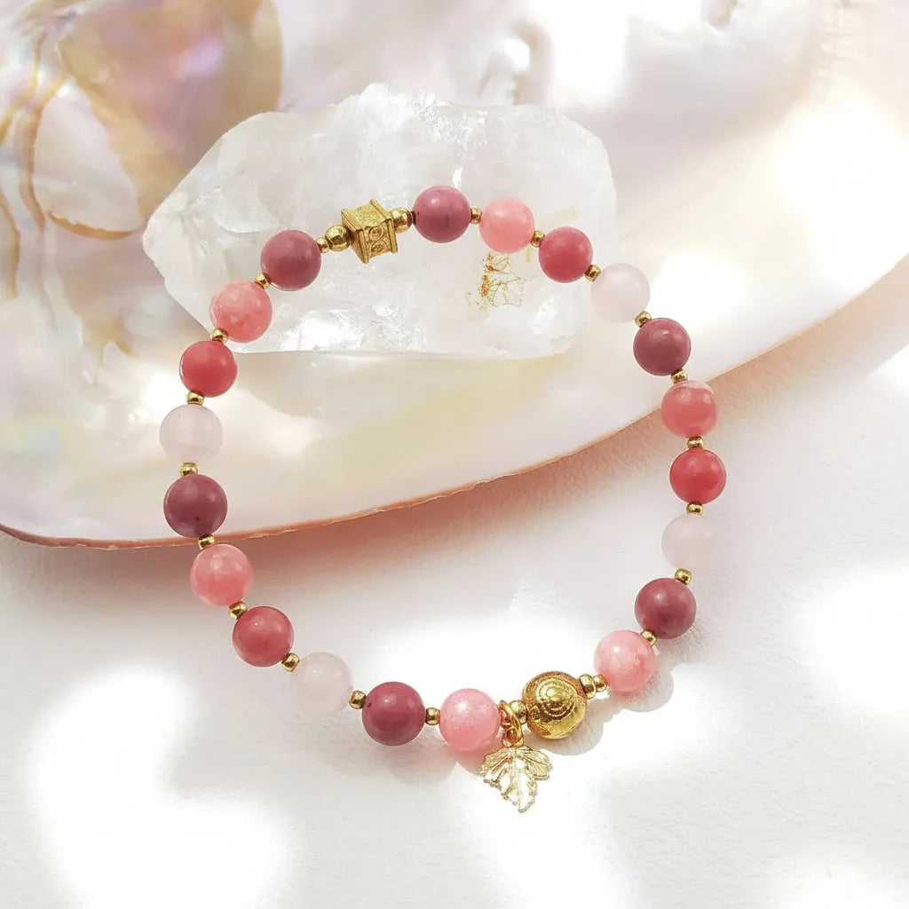 Bracelet with pink beads and gold accents on a shell background