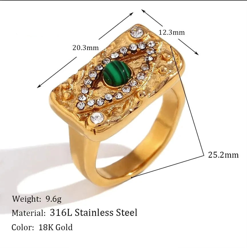 Gold ring with green gemstone and measurements on a white background