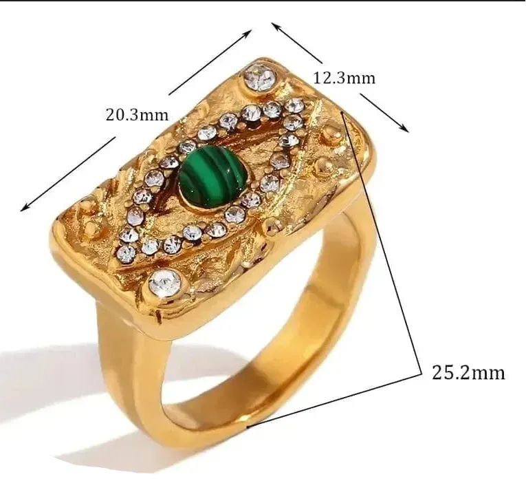 Gold ring with green gemstone and measurements on a white background
