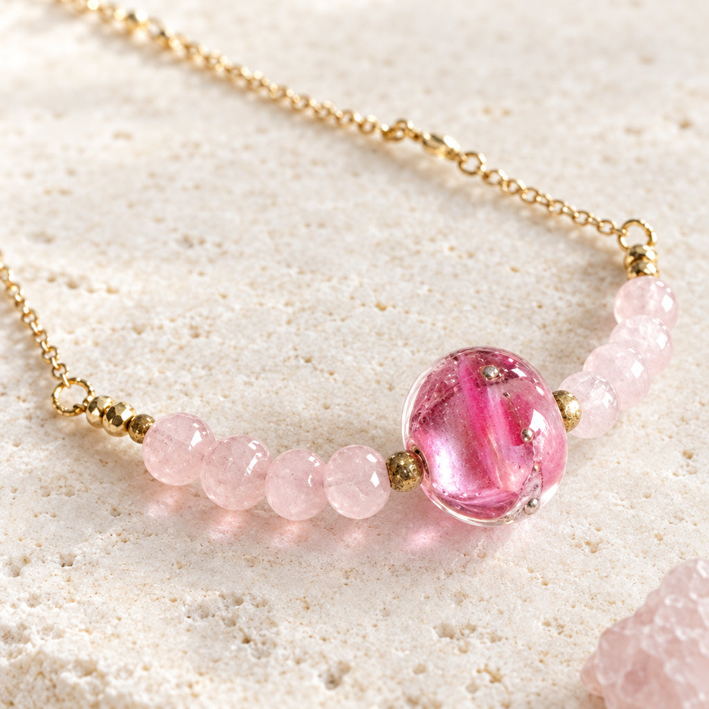 Close-up of the pink handblown glass bead on the rose quartz and moonstone necklace