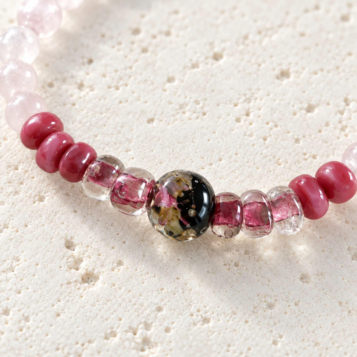 Pale pink rose quartz beads and pink handblown glass rondelles on the rose quartz stretch bracelet