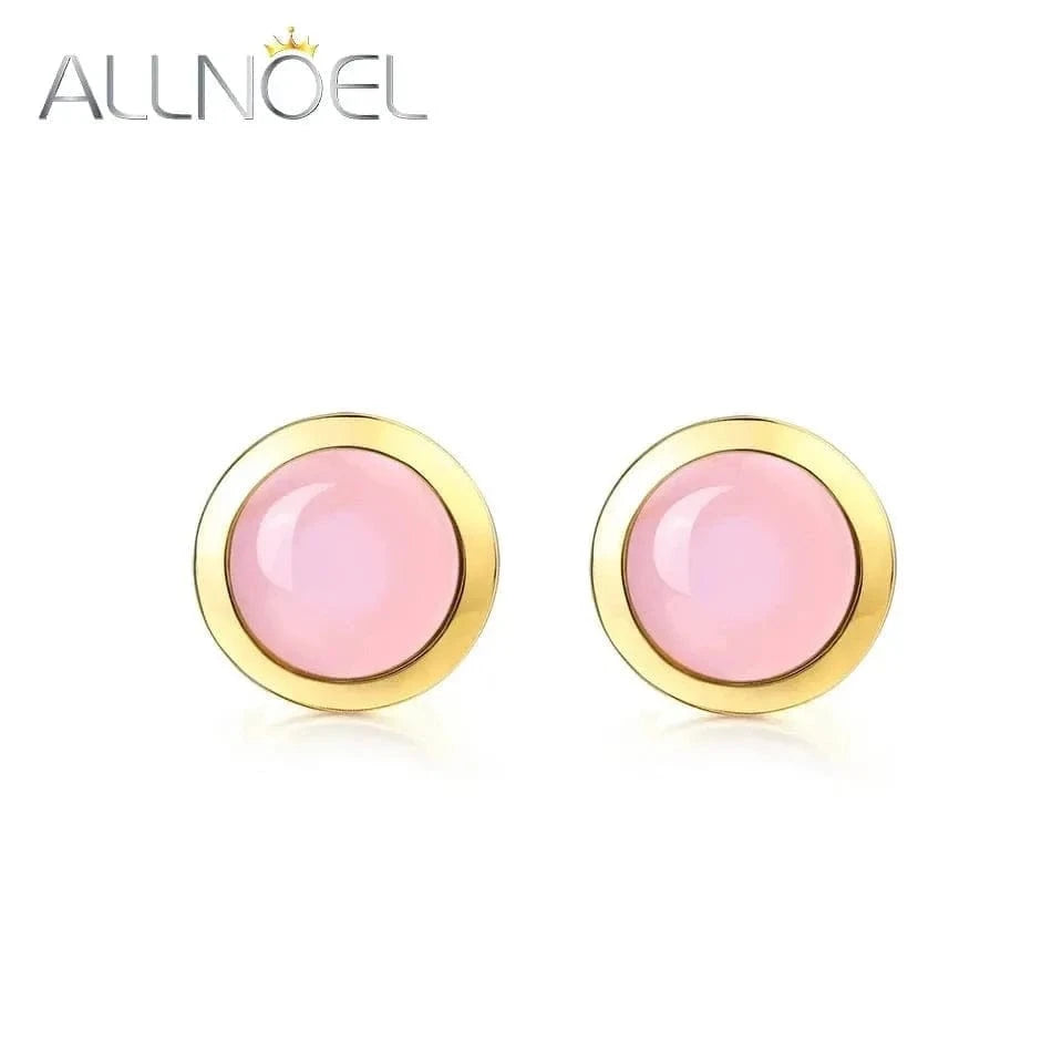 Pink earrings with gold accents on a white background