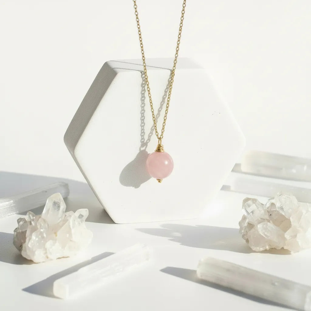 Necklace with a pink gemstone pendant on a white background