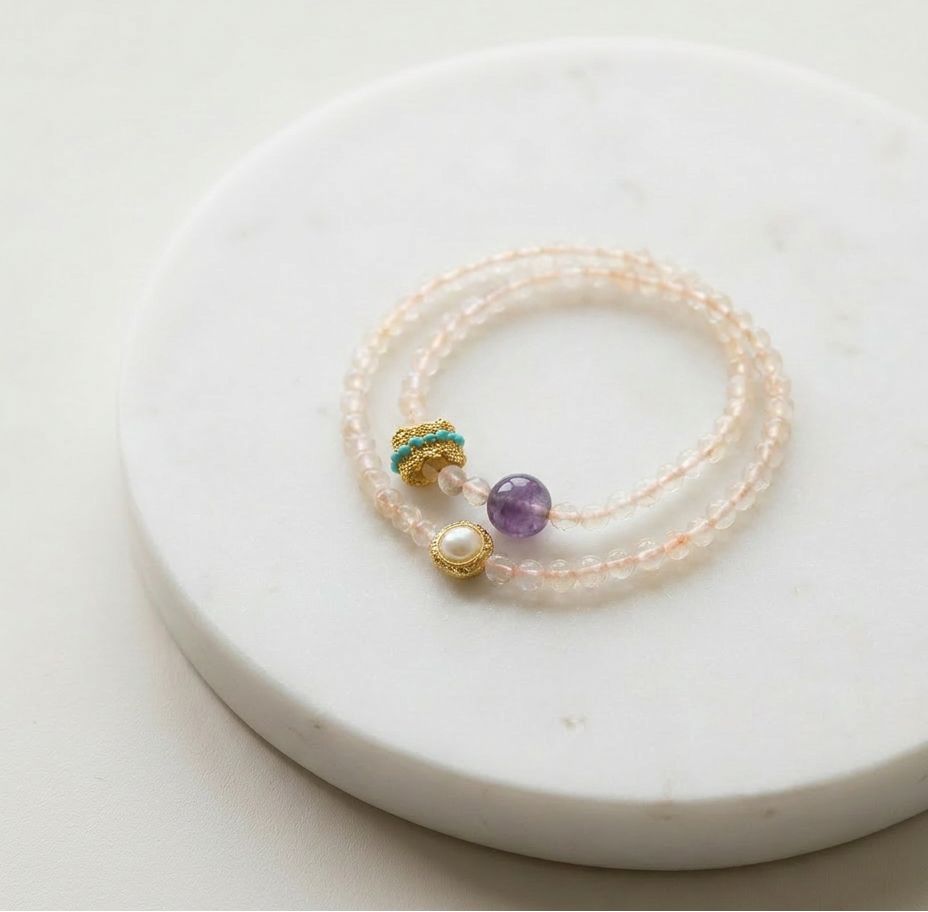 Rose Quartz Double Strand bracelet with amethyst and pearl on a white marble surface