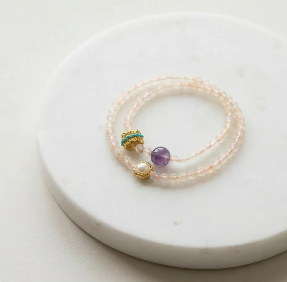 Rose Quartz Double Strand bracelet with amethyst and pearl on a white marble surface