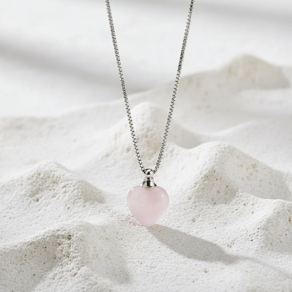 Necklace with a pink heart-shaped pendant on a black background
