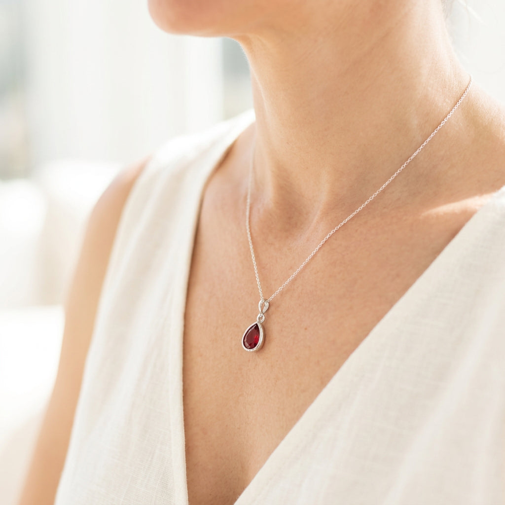 Silver teardrop pendant necklace with ruby red faceted glass drop, July birthstone colour