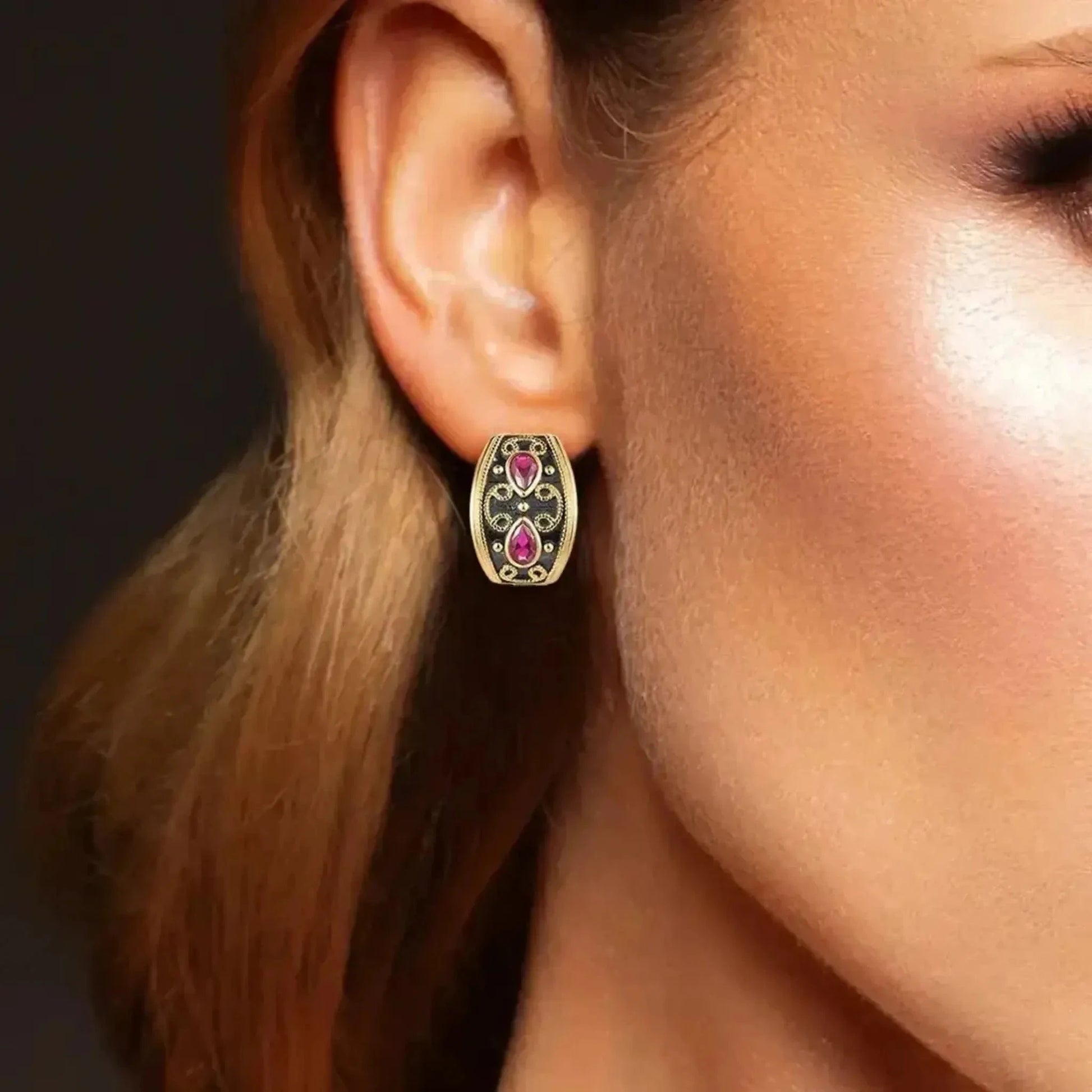 woman wearing old ruby earrings