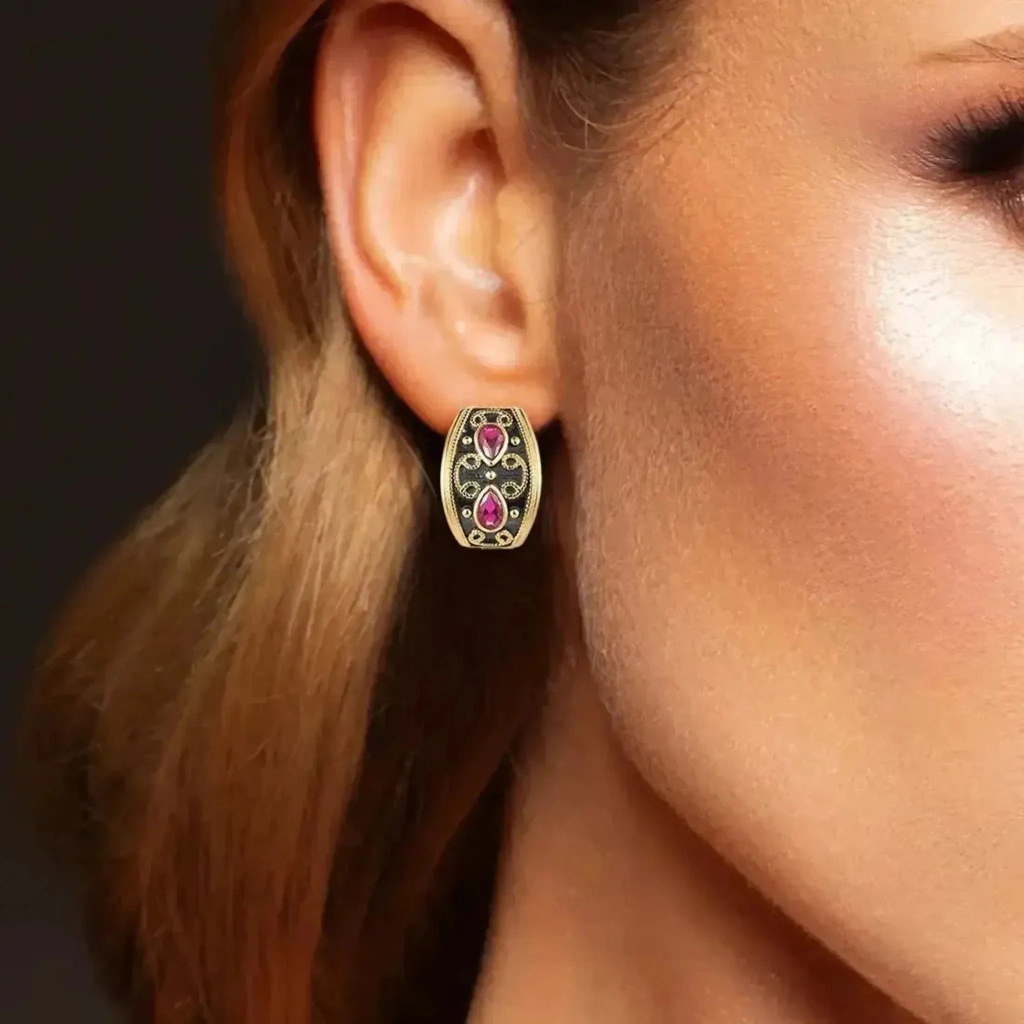 woman wearing old ruby earrings