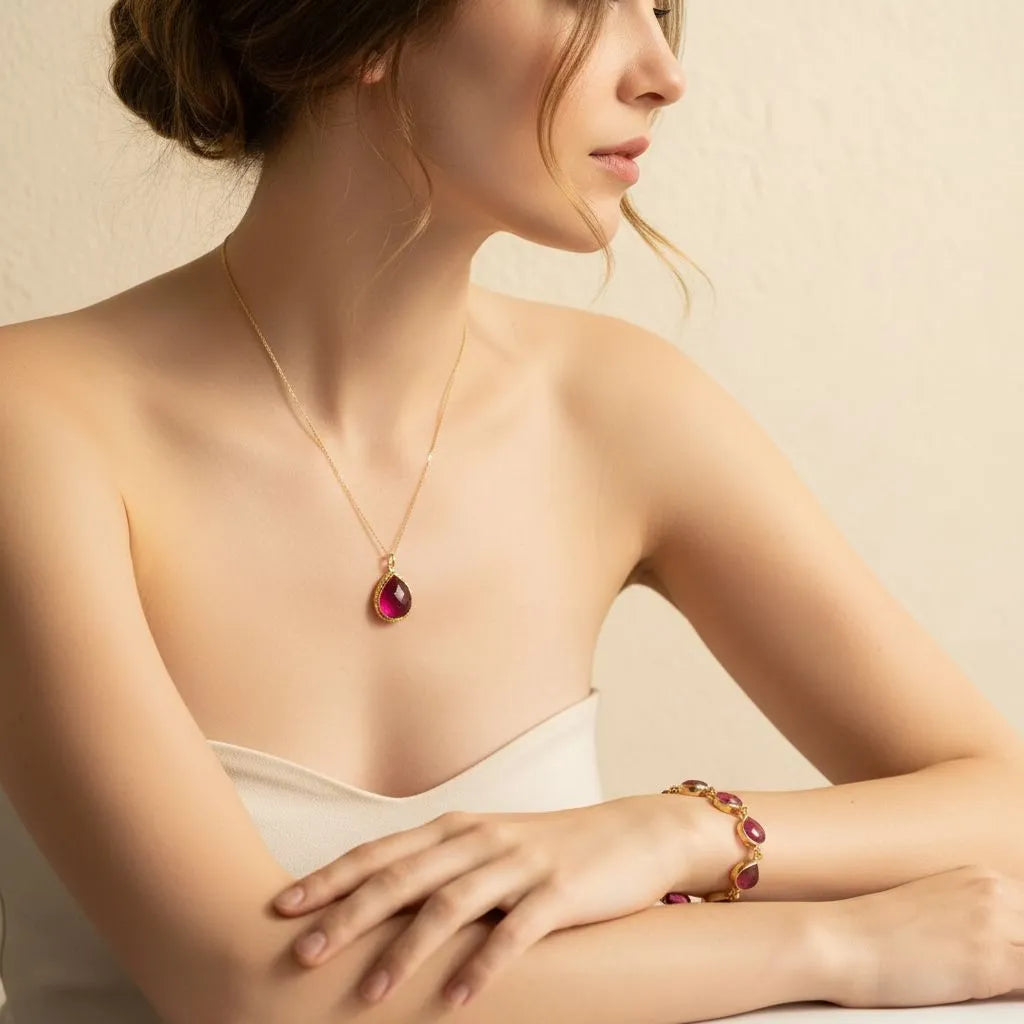 flay lay plate with ruby necklace and bracelet, vibrant tarot cards and cyrstals