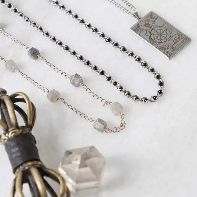 Close-up of various necklaces with different designs on a light background