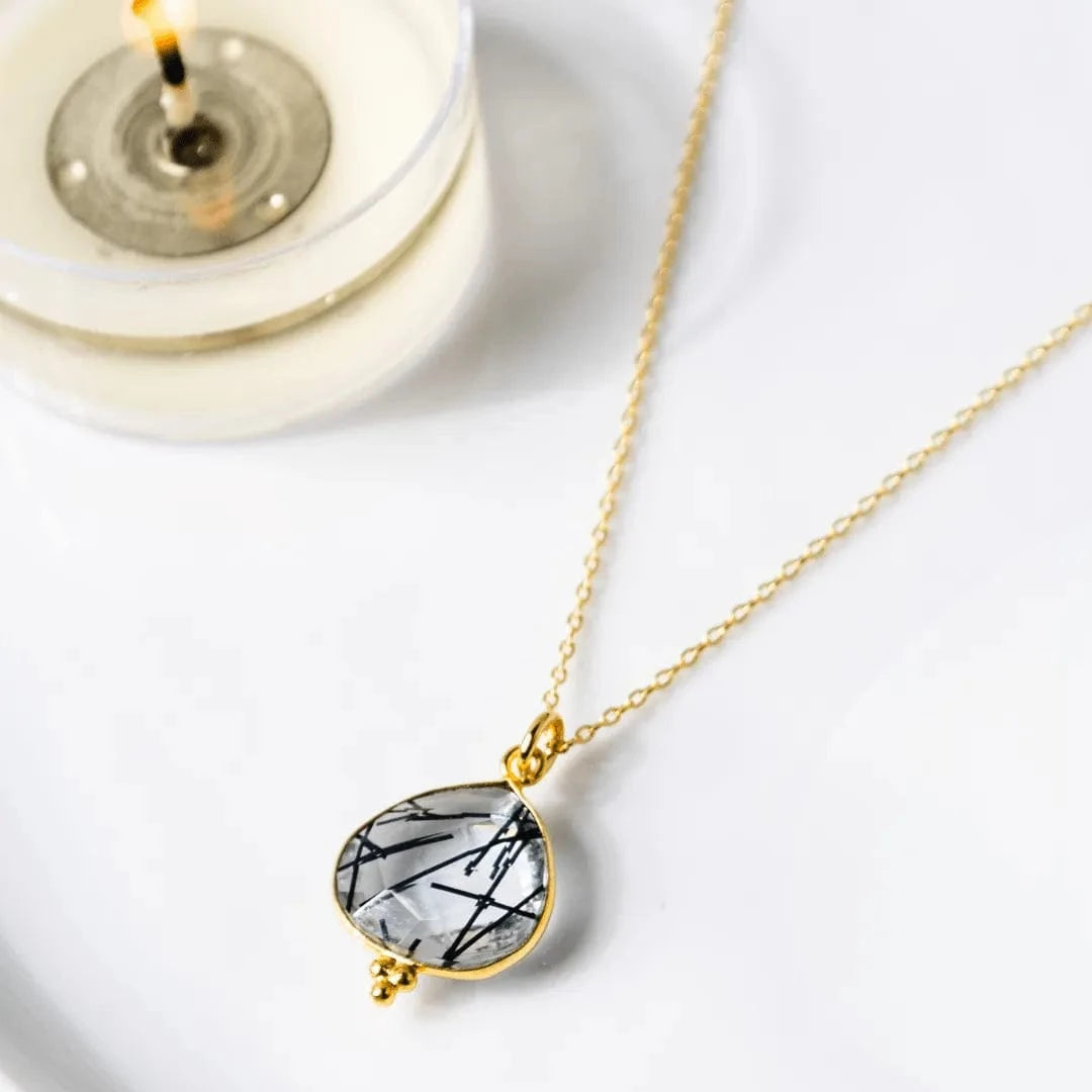 Necklace with a marbled pendant on a white background