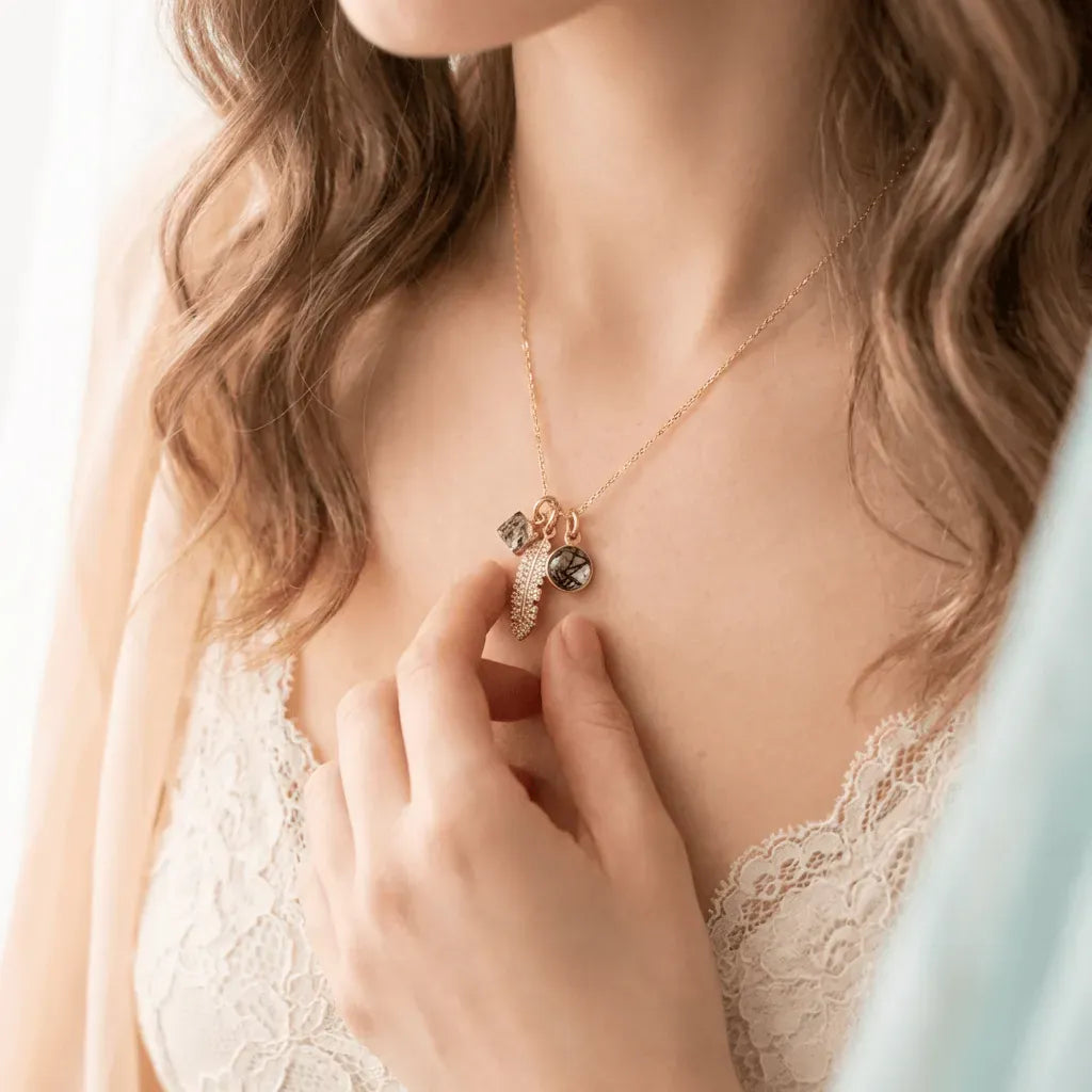 Woman wearing a gold necklace with a pendant, close-up on the neck and chest area.