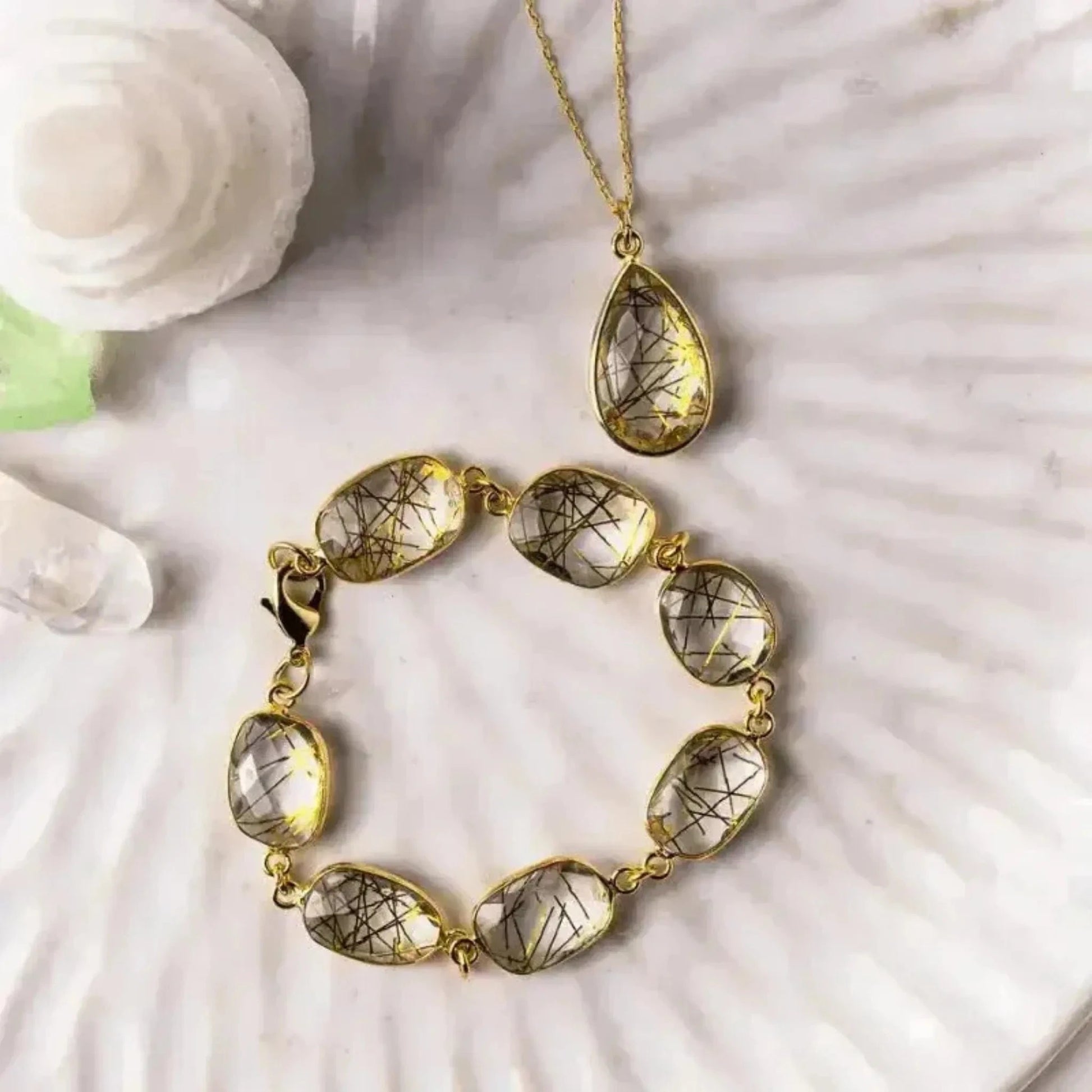 Golden rutilated quartz chain bracelet with matching teardrop necklace in gold