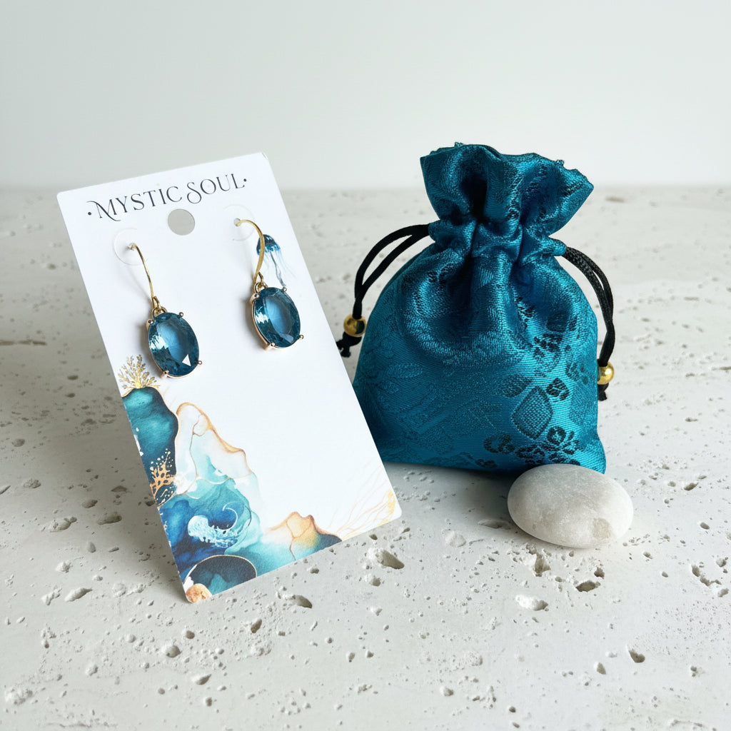 Gold sapphire blue ombré glass drop earrings on card with Mystic Soul Jewelry gift bag