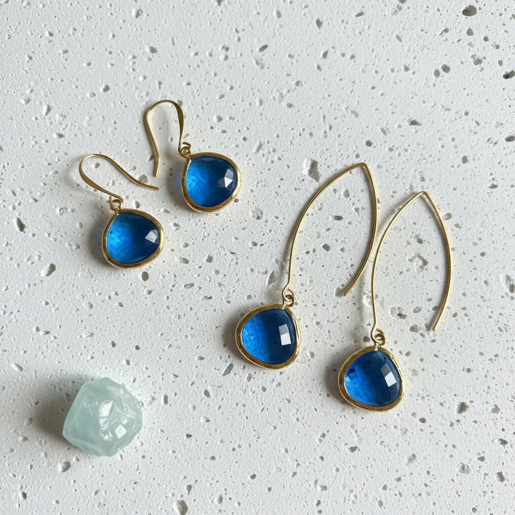 Sapphire Elegant Pebble earrings in gold shown on the long wire and the shepherd's hook