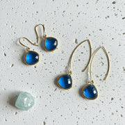 Sapphire Elegant Pebble earrings in gold shown on the long wire and the shepherd's hook