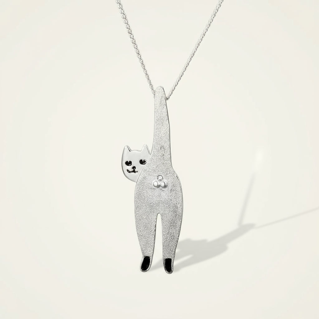 Silver cat-shaped pendant on a chain against a gray background