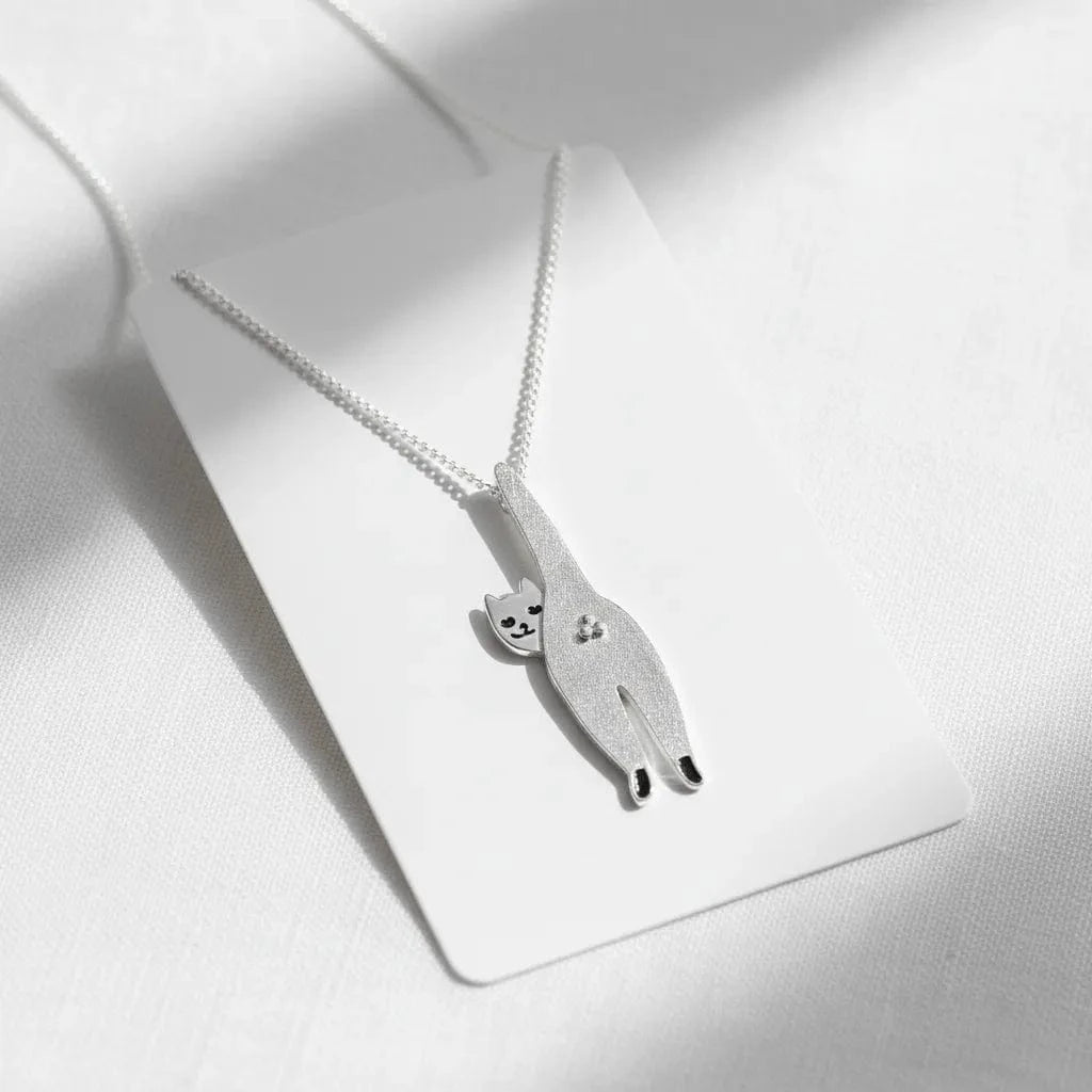 Silver cat-shaped pendant necklace on a white background