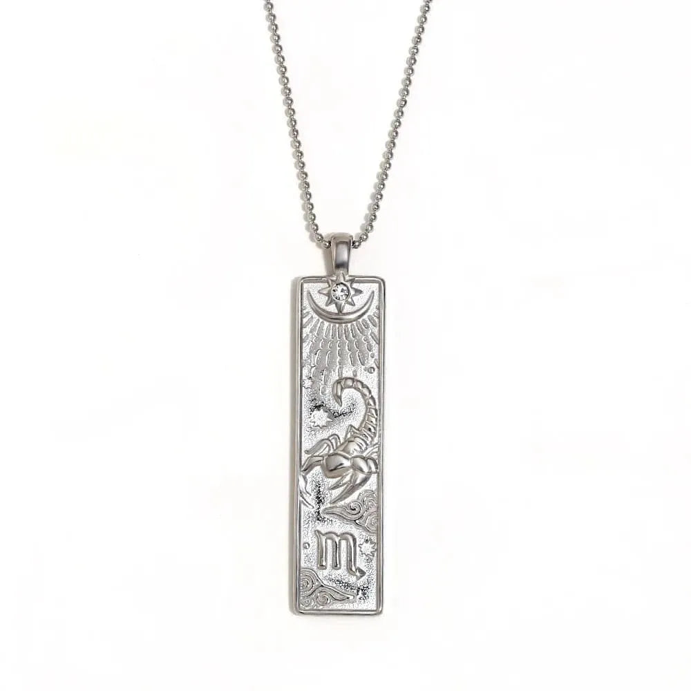 Silver pendant necklace with intricate design on a white background