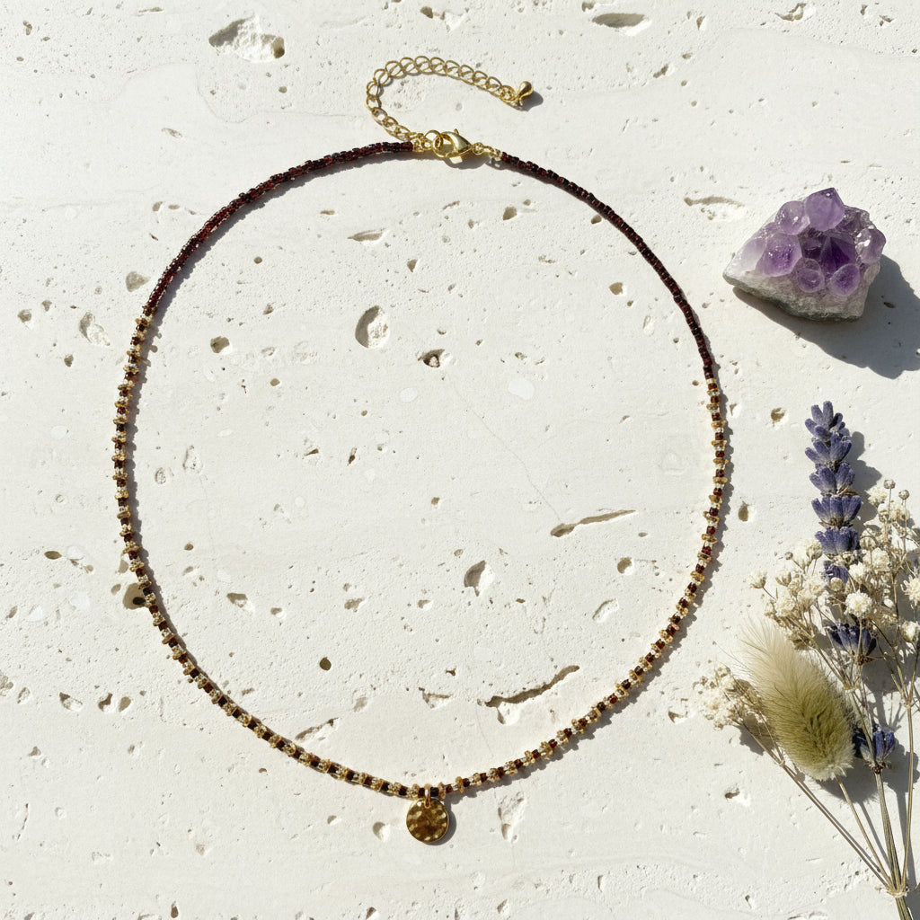 Necklace with gold and brown beads on a white background