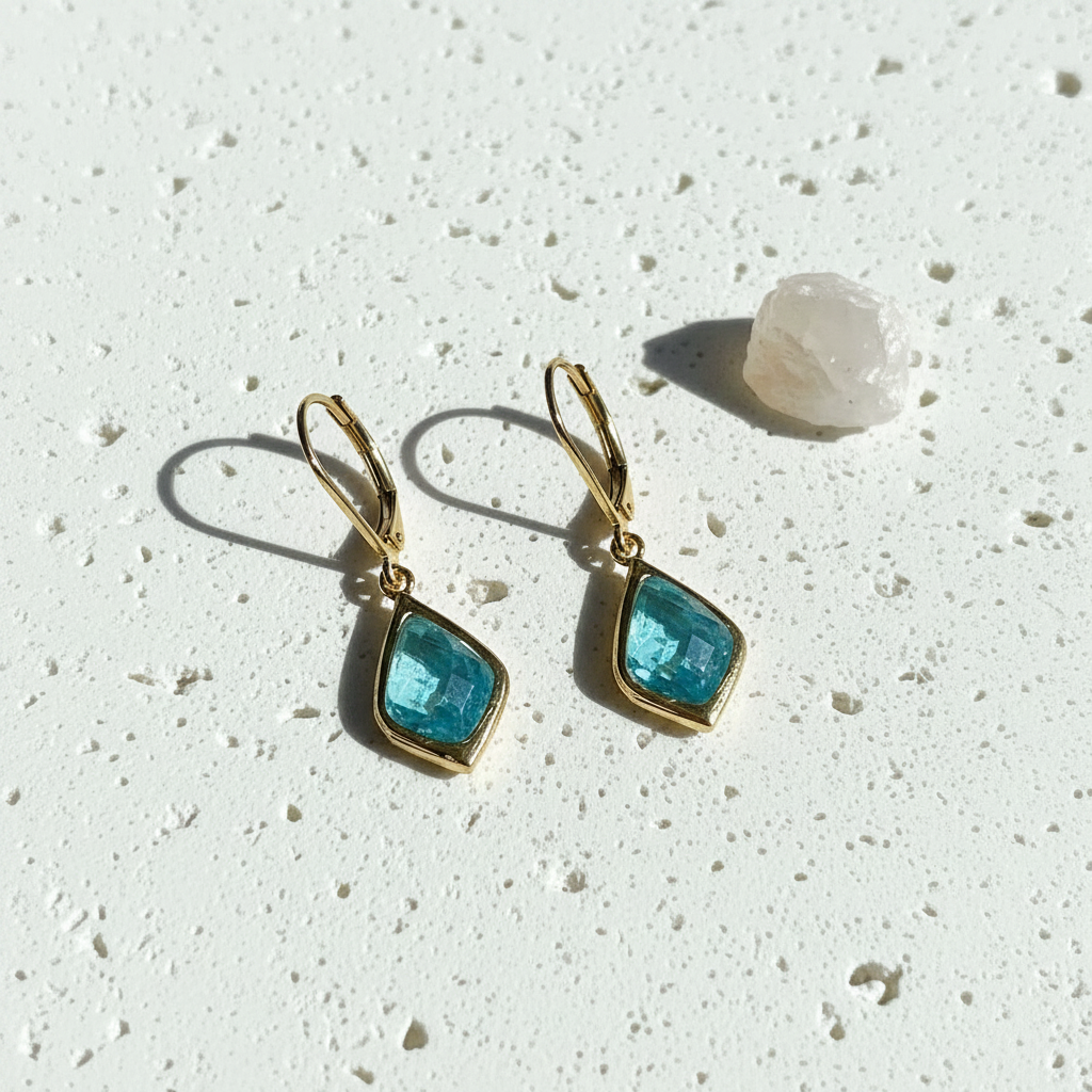 Gold Selene drop earrings with aqua faceted glass