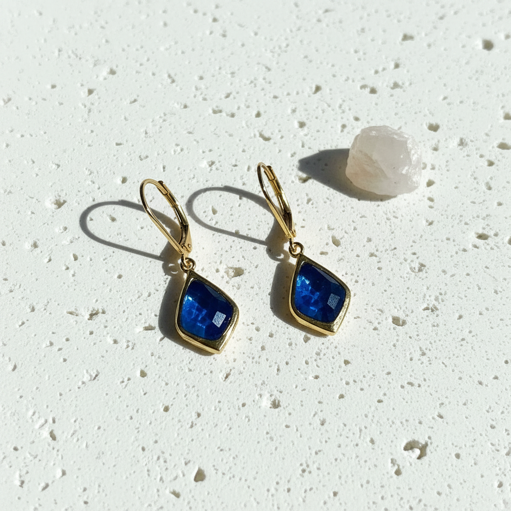 Gold Selene drop earrings with capri blue faceted glass