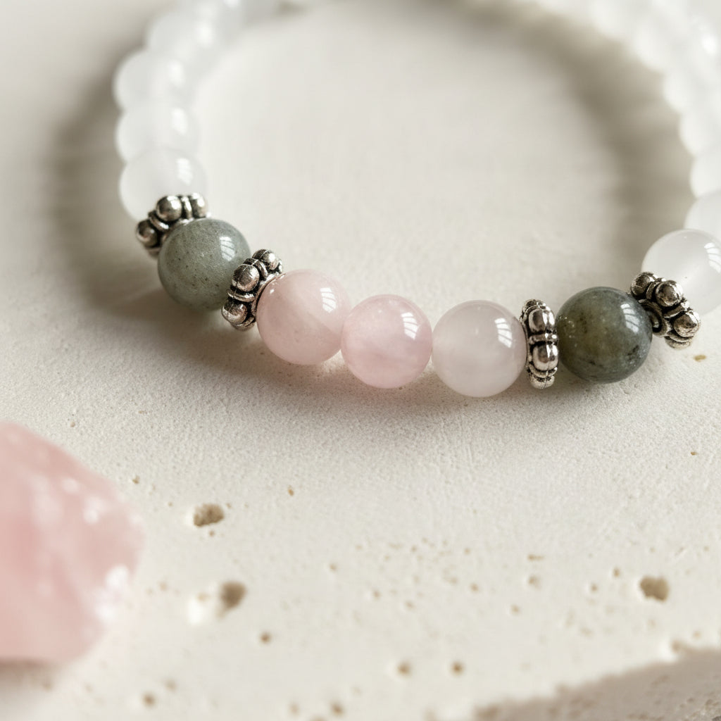 Selenite stretch bracelet close-up showing white selenite beads with labradorite and rose quartz at the front