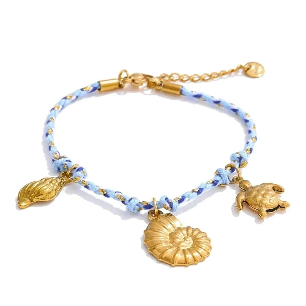 Bracelet with gold charms on a white background