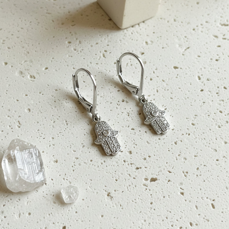 Silver hamsa hand earrings set with sparkling crystals