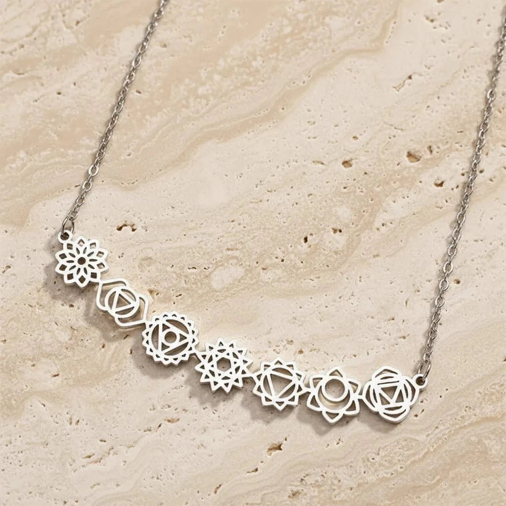 Silver necklace with floral designs on a black background