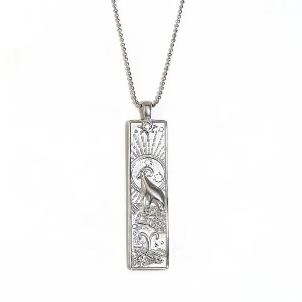 Silver pendant necklace with intricate design on a white background