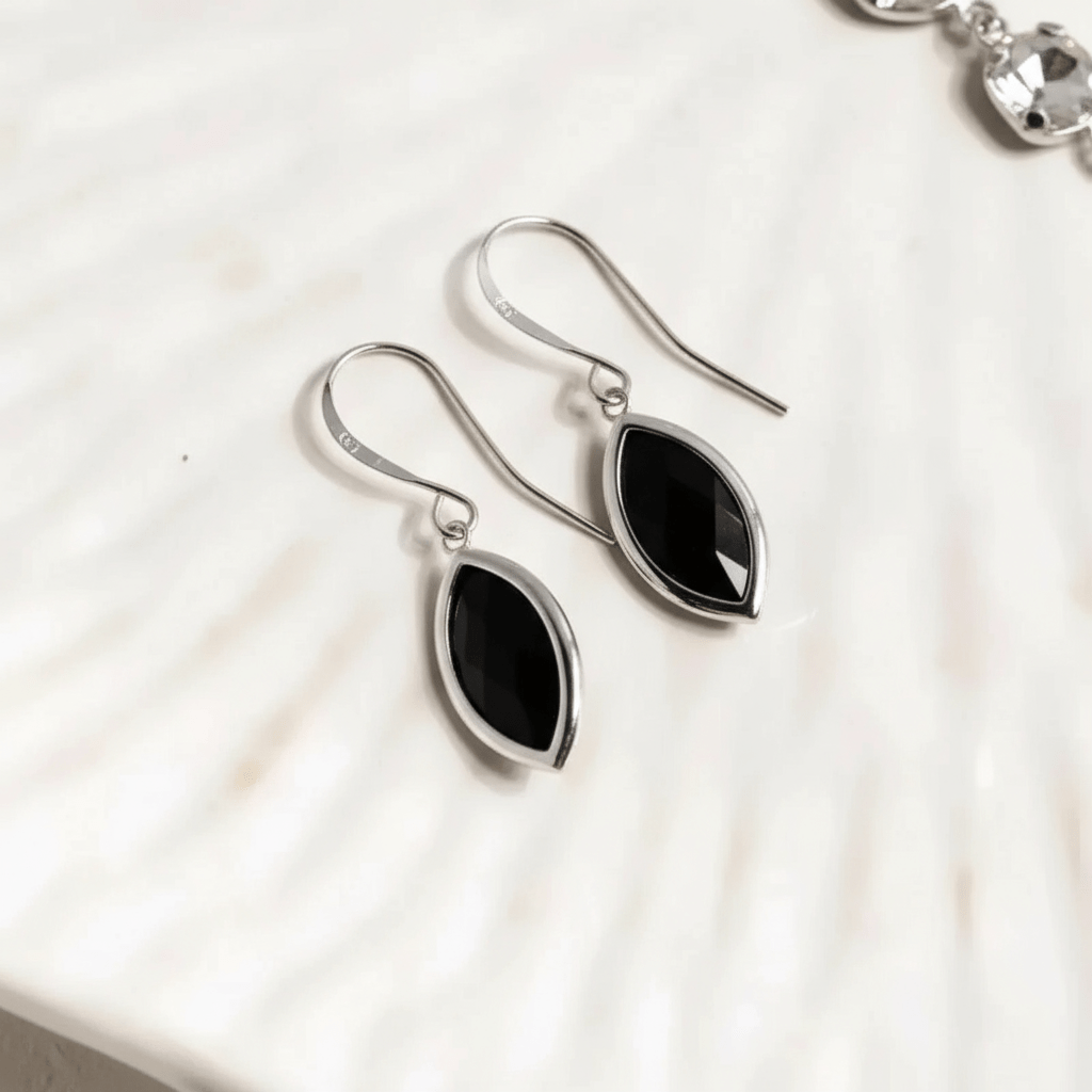 Black teardrop earrings on a white background