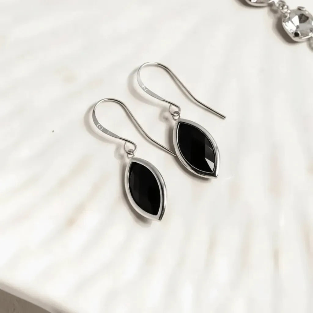 Black teardrop earrings on a white background