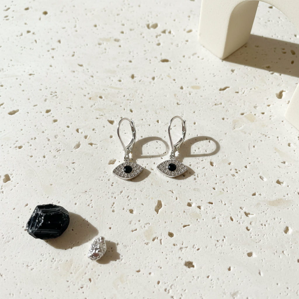 Silver plated mini evil eye leverback earrings with black centres