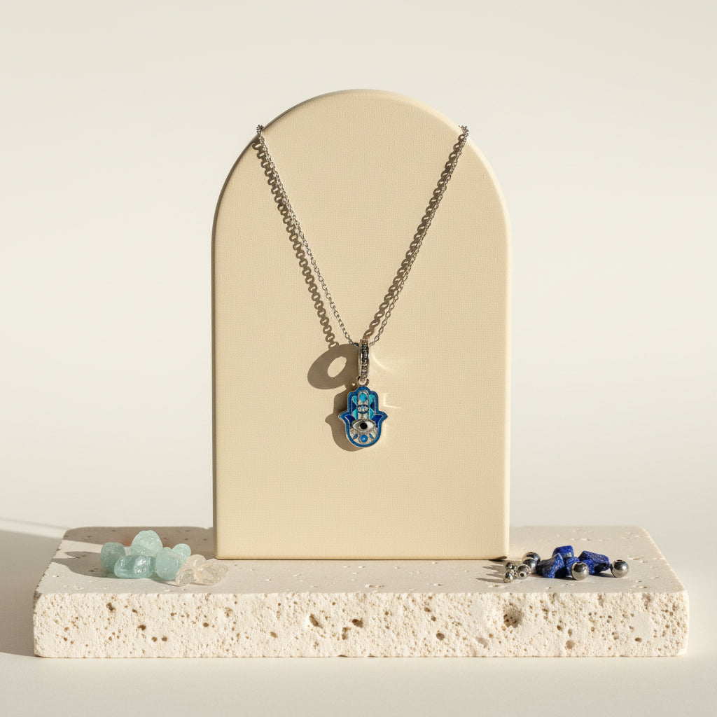 Sterling silver hamsa hand pendant with a deep blue centre on a silver chain