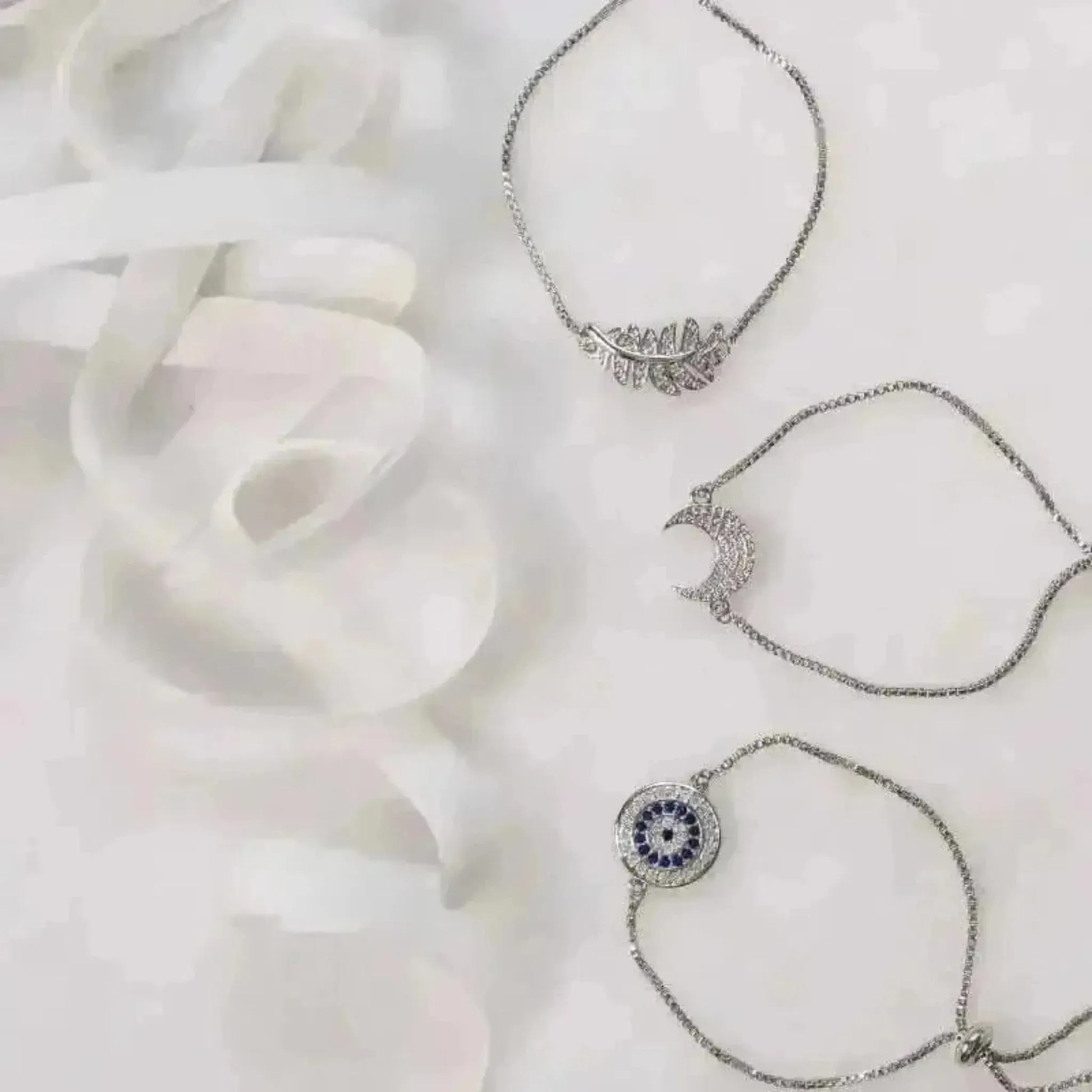silver bracelets leaf evil eye and moon