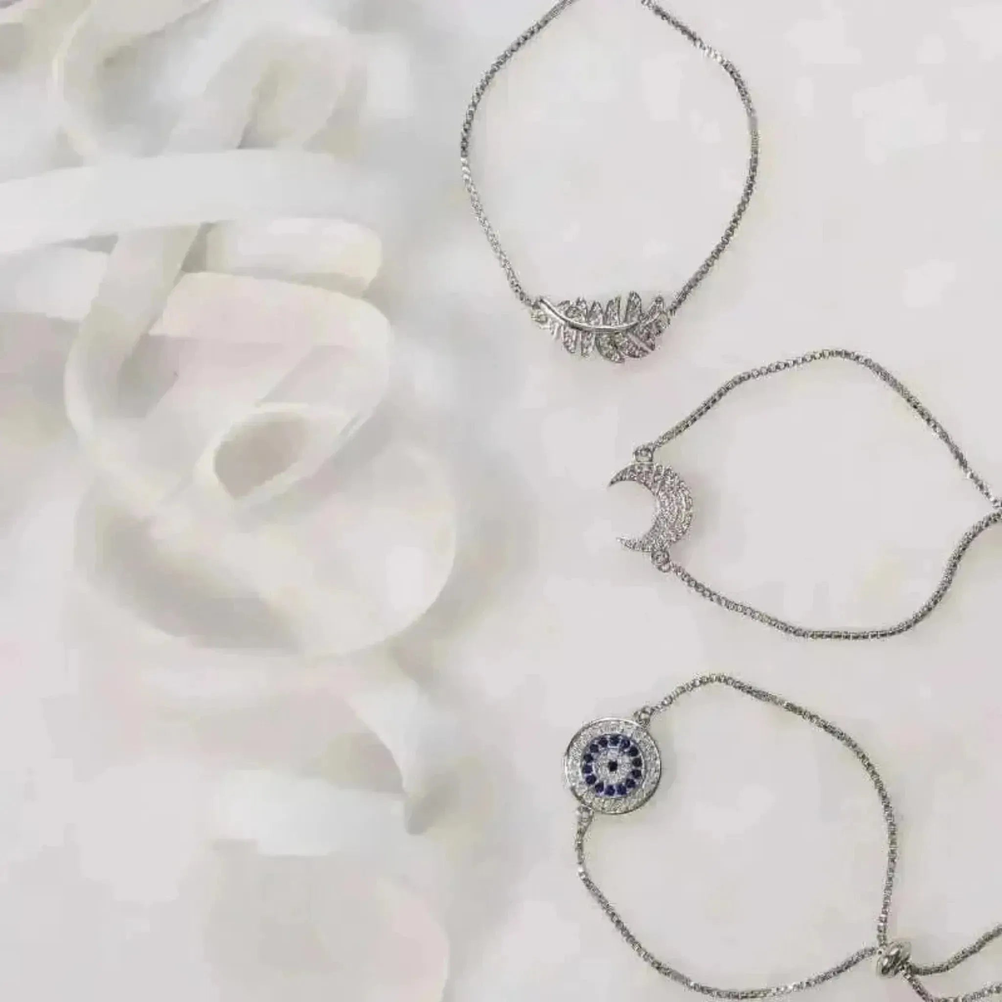 silver bracelets leaf evil eye and moon