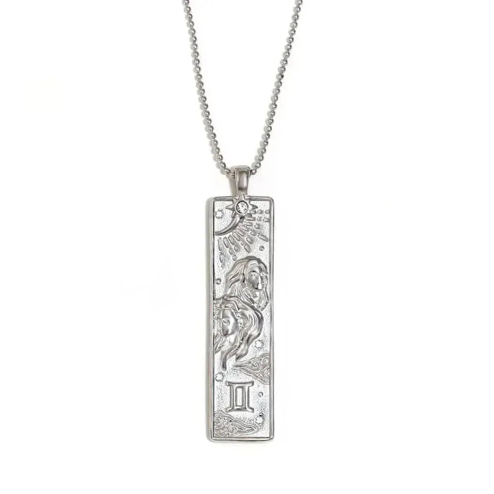 Silver pendant with zodiac design on a white background