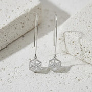 Gold geometric earrings on a white background