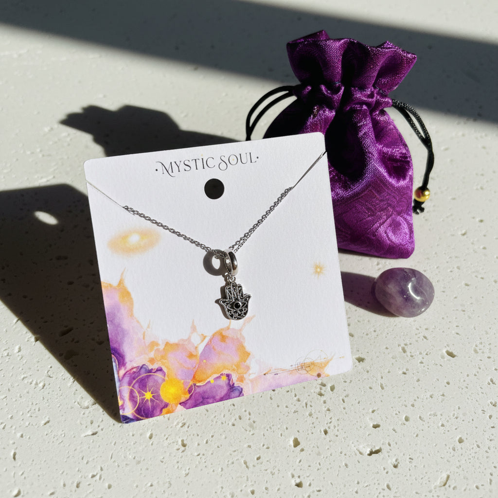 Cut-out sterling silver hamsa hand pendant necklace displayed on a presentation card