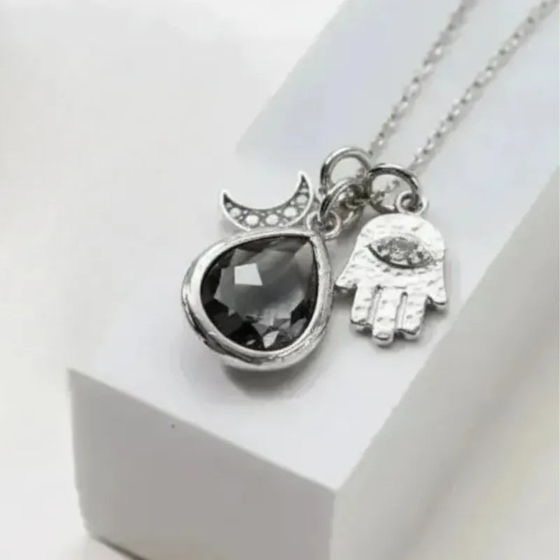Dusk grey hamsa hand necklace in silver, protection symbol jewelry