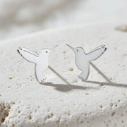 Hummingbird-shaped earrings on a white background  