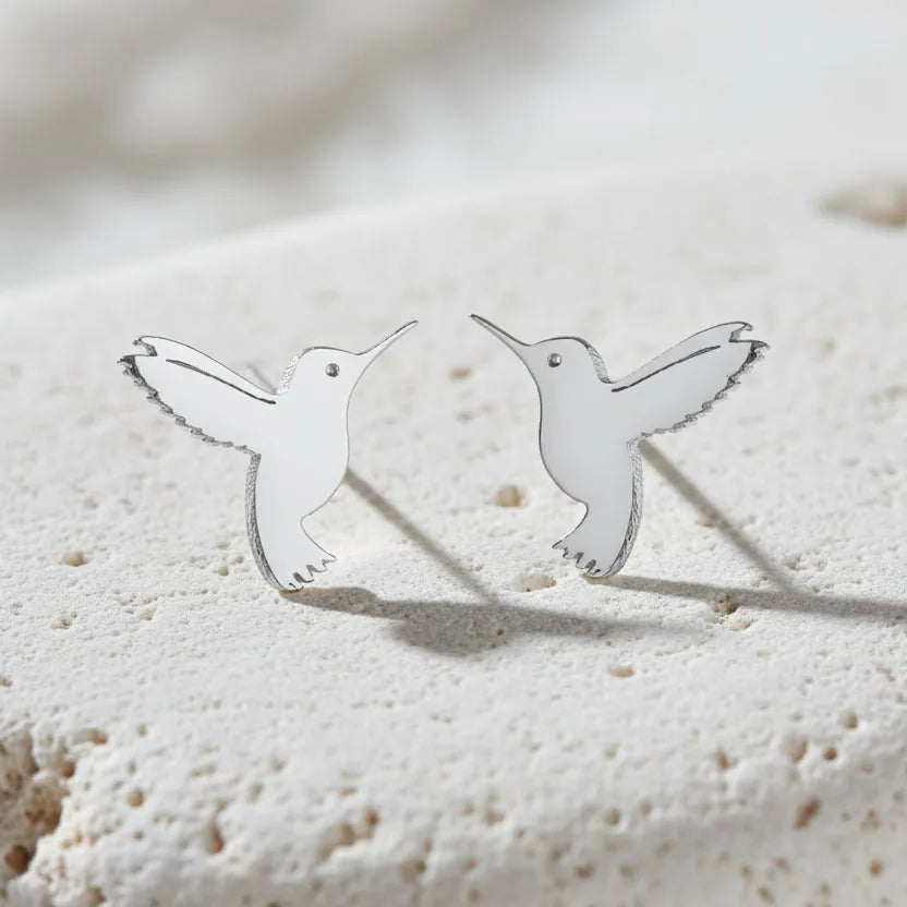 Hummingbird-shaped earrings on a white background  
